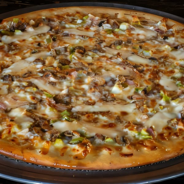 A Task Force Pizza with melted cheese, mushrooms, and green onions on a dark pan.