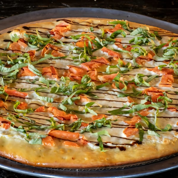 Task Force Pizza's white pizza with fresh basil, tomatoes, and balsamic glaze.